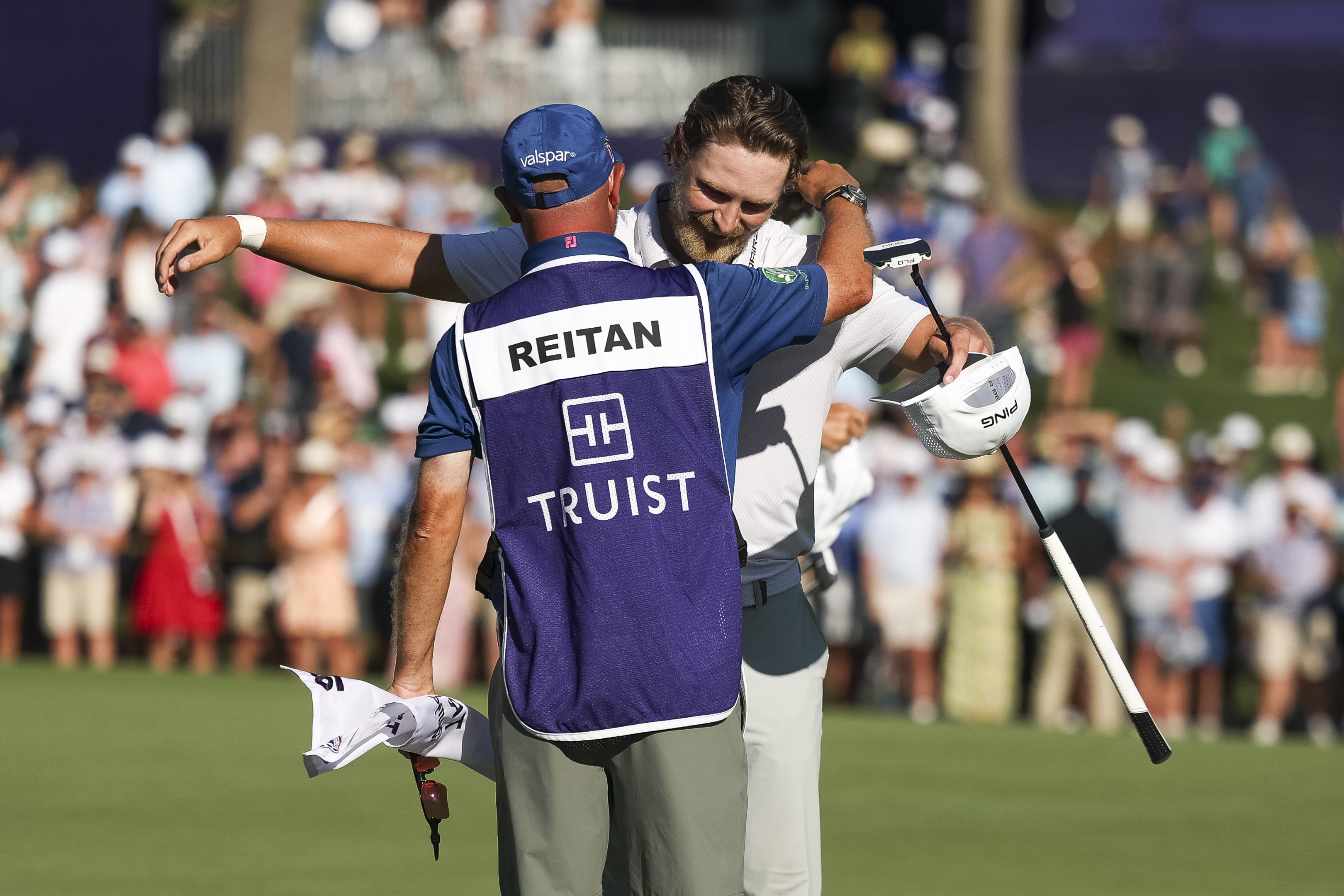 Kristoffer Reitan hugs his caddie on the 18th green after winning the Truist Championship
