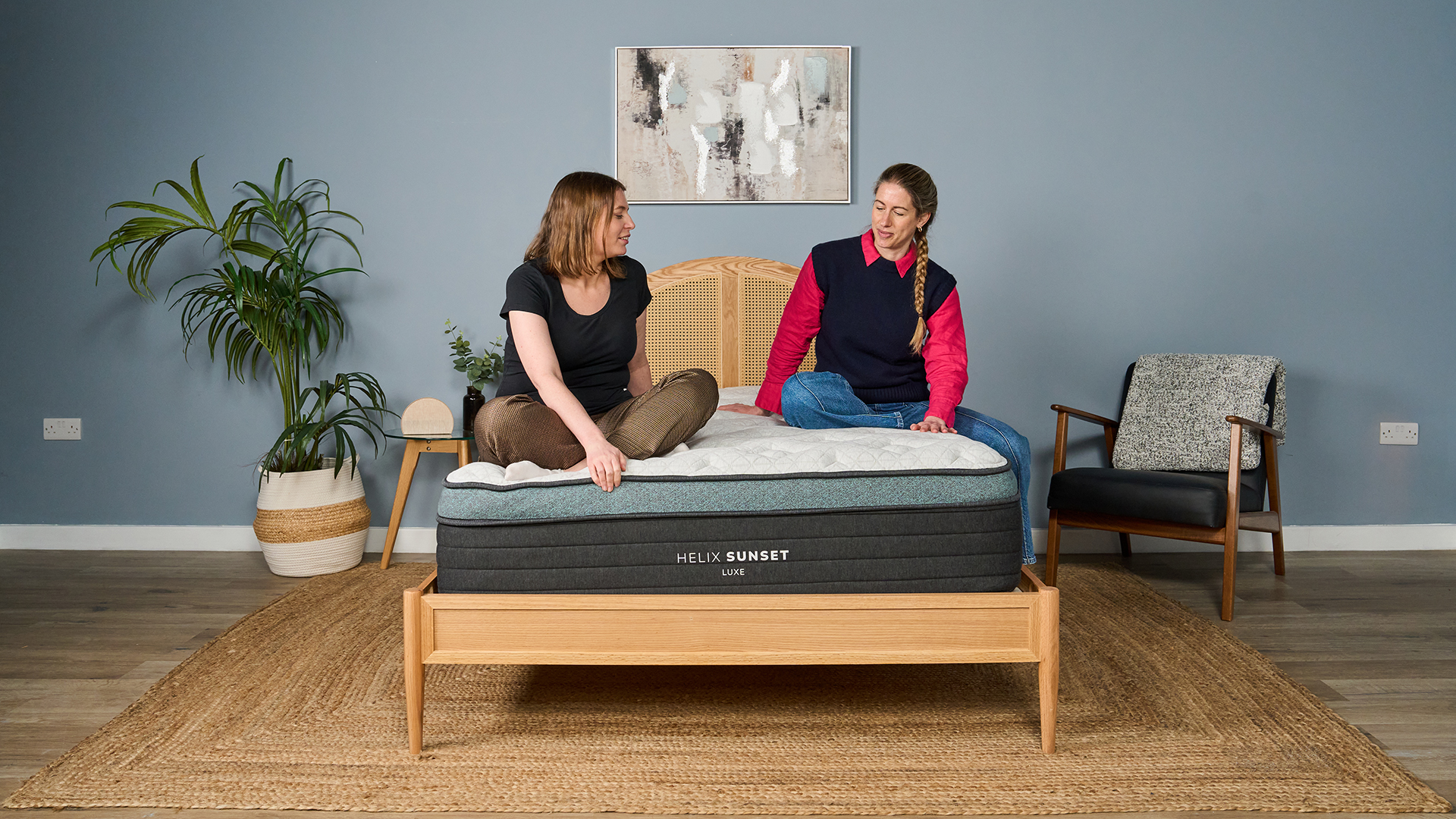 Mattress testers Ruth Jones and Nicola Appleton sit on a Helix Sunset Luxe Mattress in the Tom's Guide Sleep Studio.