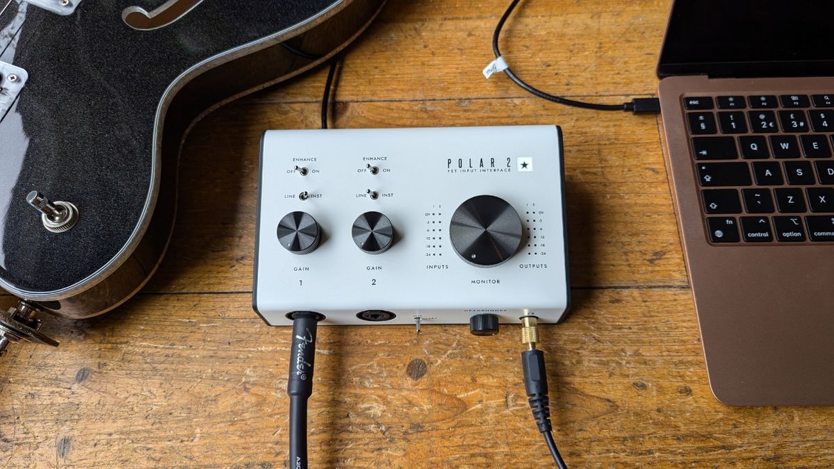 A Blackstar Polar 2 audio interface on a wooden floor with a laptop and a semi-hollow guitar