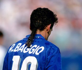 A photo taken from behind of Roberto Baggio playing for Italy at the 1994 World Cup, with his iconic ponytail on show