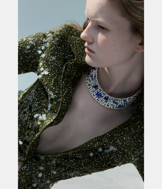 woman with red hair wearing jewellery