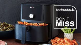 An Instant Air Fryer on a countertop with chips in its open drawer, and bowles of asparagus, celery, potato croquets and steak around it