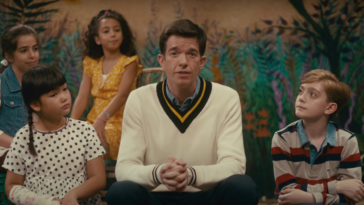 John Mulaney sitting with members of the Sack Lunch Bunch in John Mulaney & the Sack Lunch Bunch