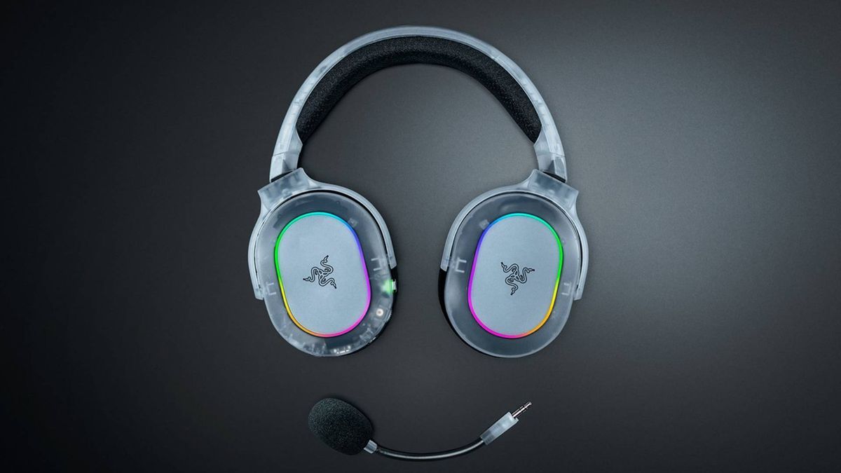 Promo image showing a translucent Razer headset and its detachable microphone sitting on a black table.