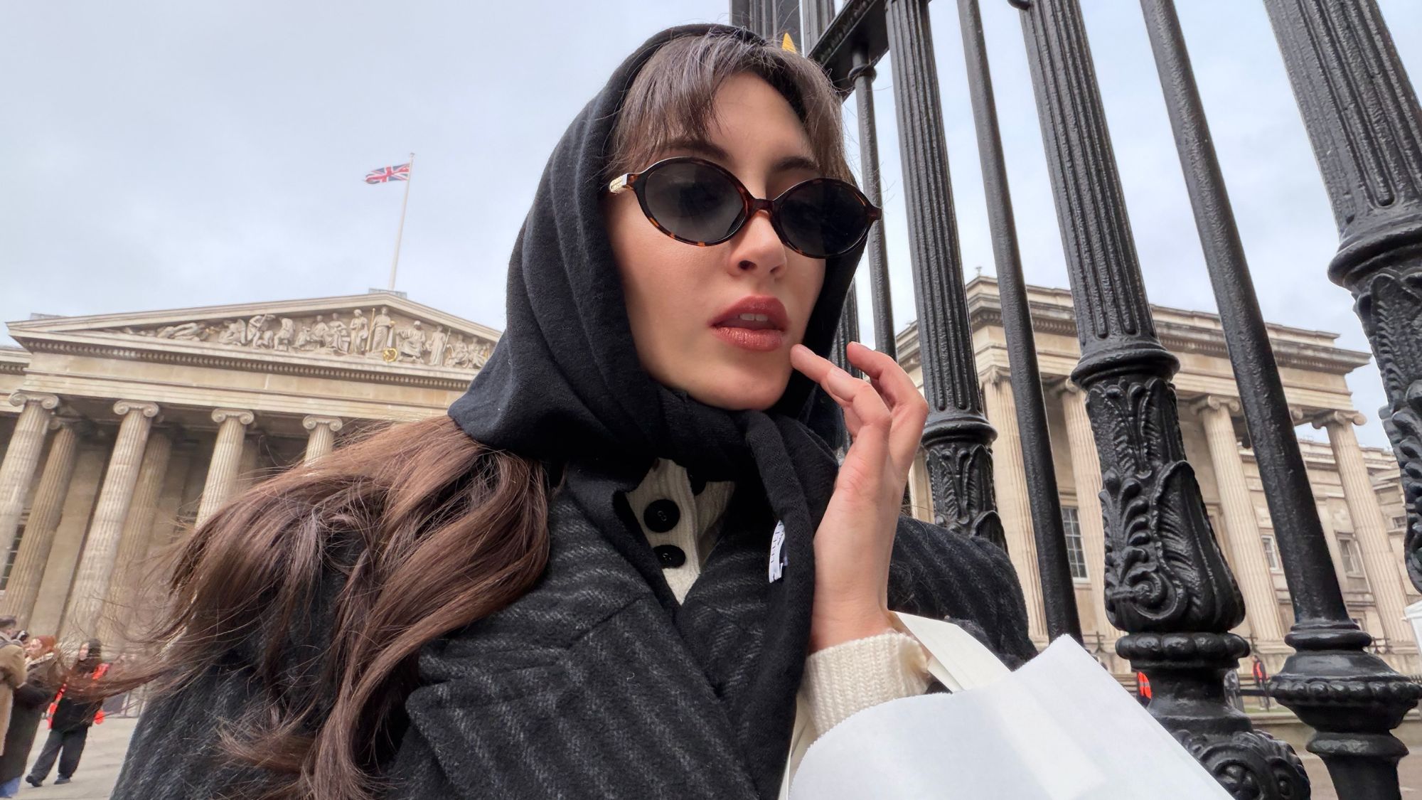 An image of Alyssa Brascia wearing a head scarf and sunglasses in London.