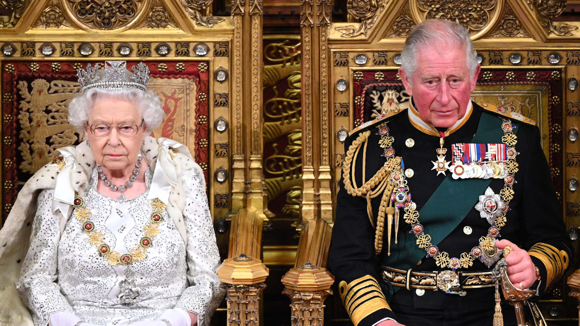 Queen Elizabeth and King Charles sitting on thrones
