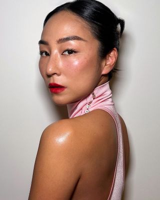 Greta Lee with middle parting bun