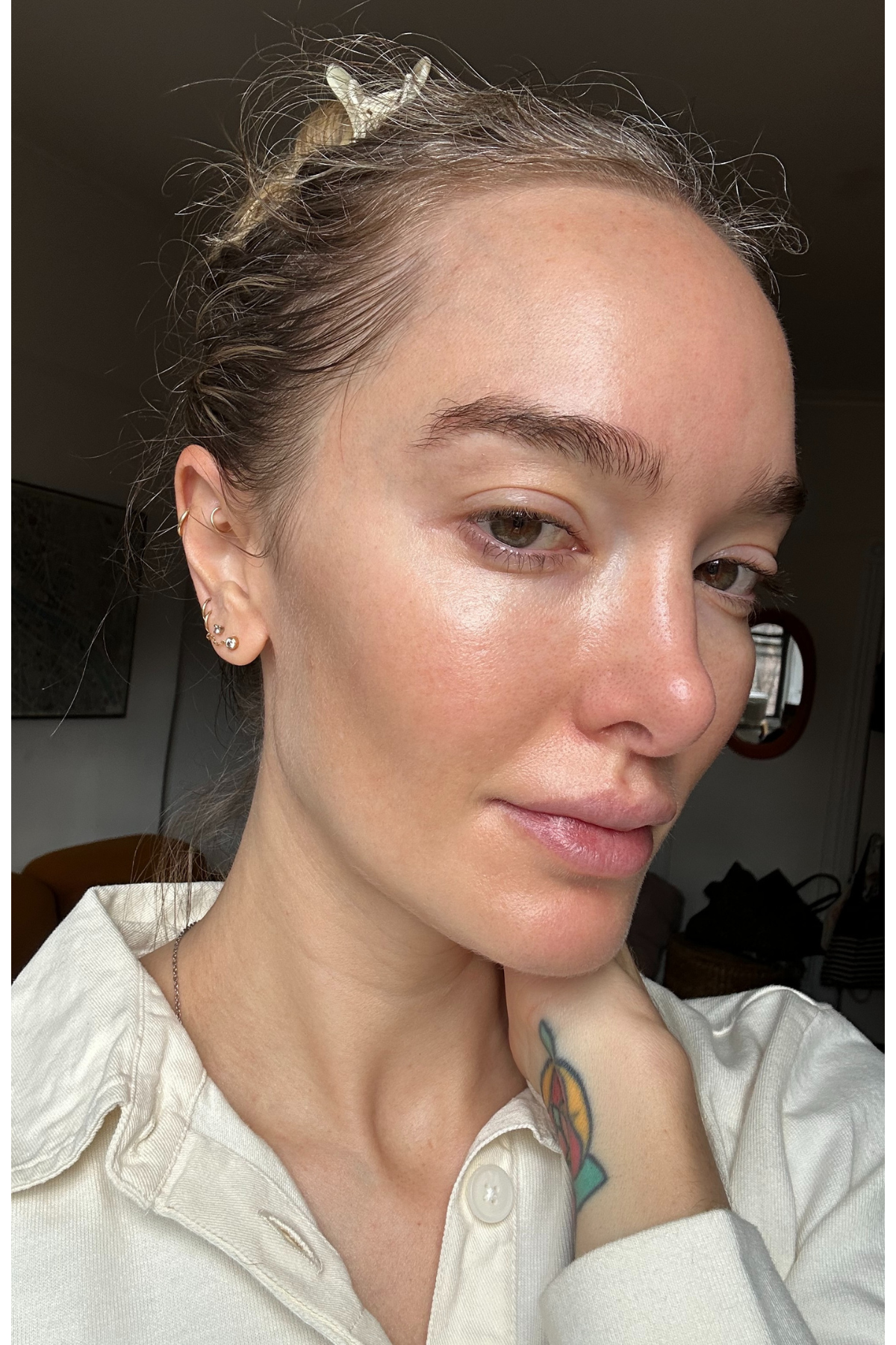 Hannah Baxter in a white shirt with bare skin