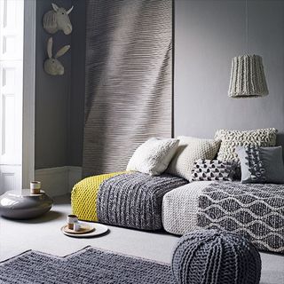 Grey living room sofa with wool furnishings and accessories