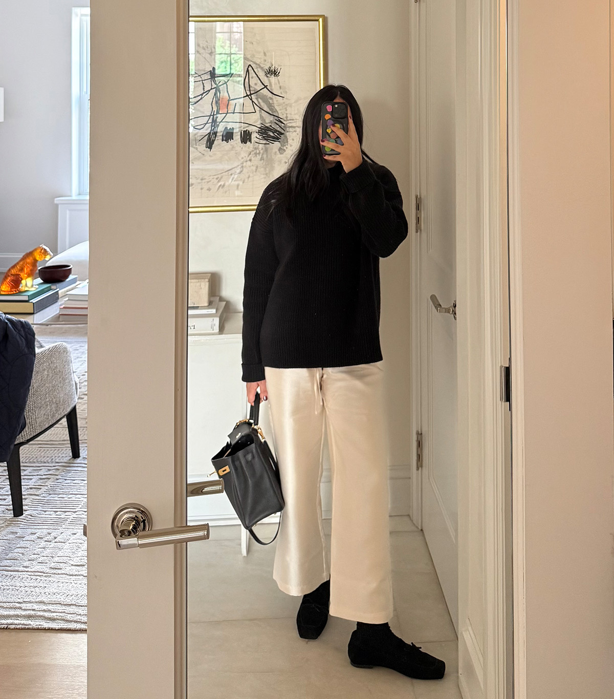 @nicoleakhtarzad taking a mirror selfie wearing a winter outfit.