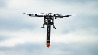 A customized quadcopter operated by U.K. start-up Gravitilab carries a microgravity pod before its first test flight.