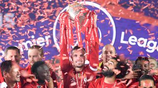 LIVERPOOL, ENGLAND - JULY 22: Jordan Henderson of Liverpool holds the Premier League trophy aloft