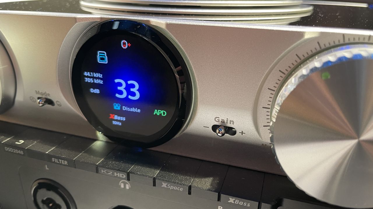 The formidable iFi iDSD Phantom in Tower Bridge, London, used with headphones and illuminating the front panel