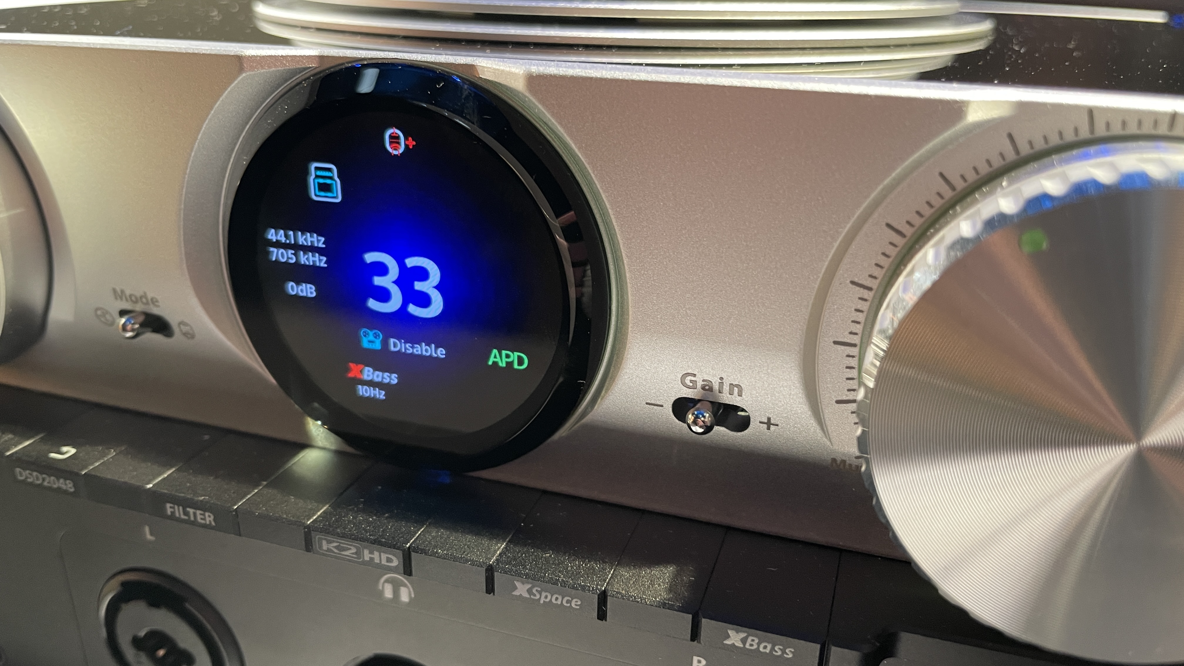 The formidable iFi iDSD Phantom in Tower Bridge, London, used with headphones and illuminating the front panel 