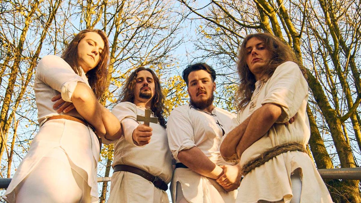 Wytch Hazel, dressed in white, standing in a wood