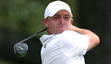 Rory McIlroy hits a fairway wood