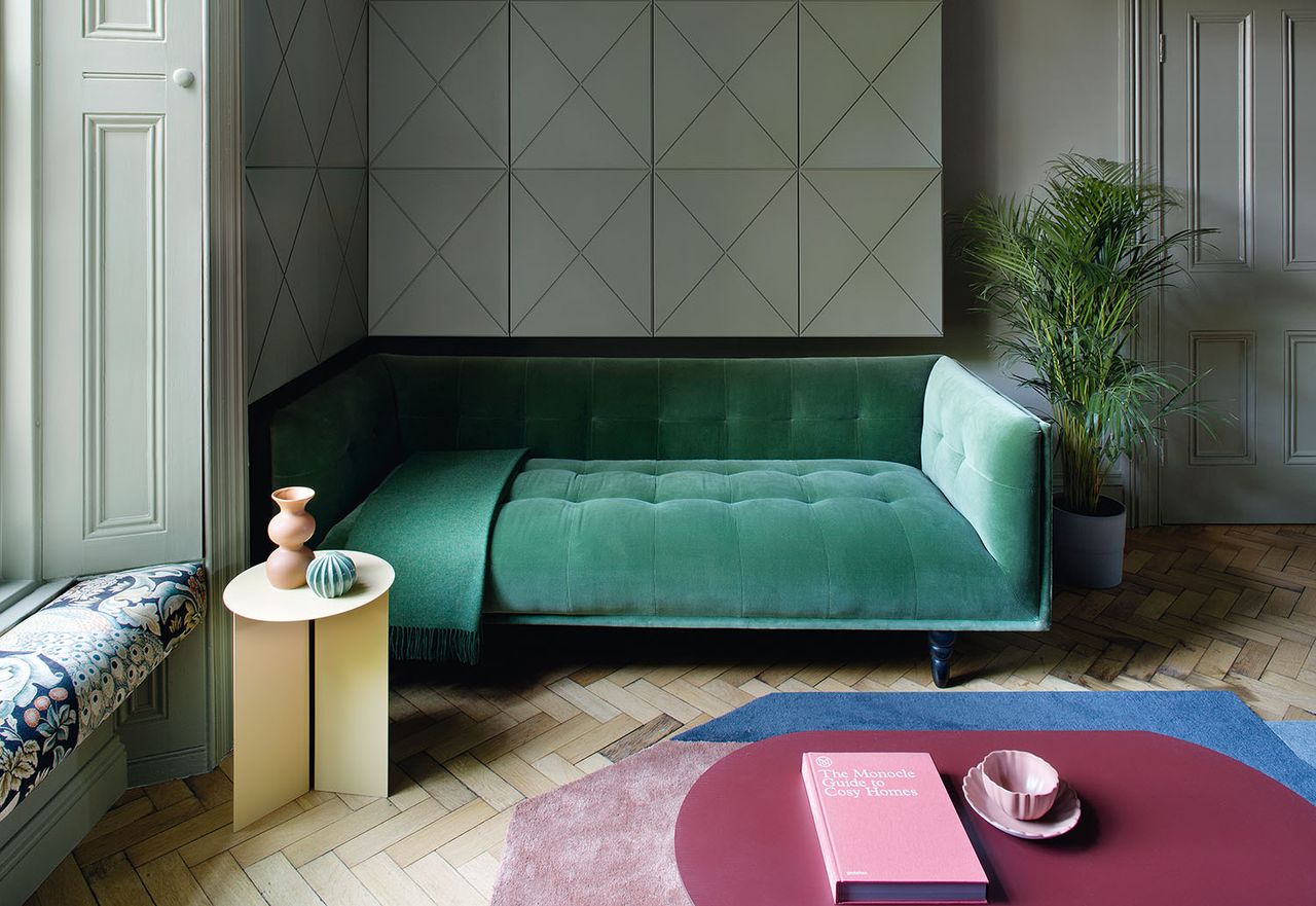 green living room with green day bed and burgundy table