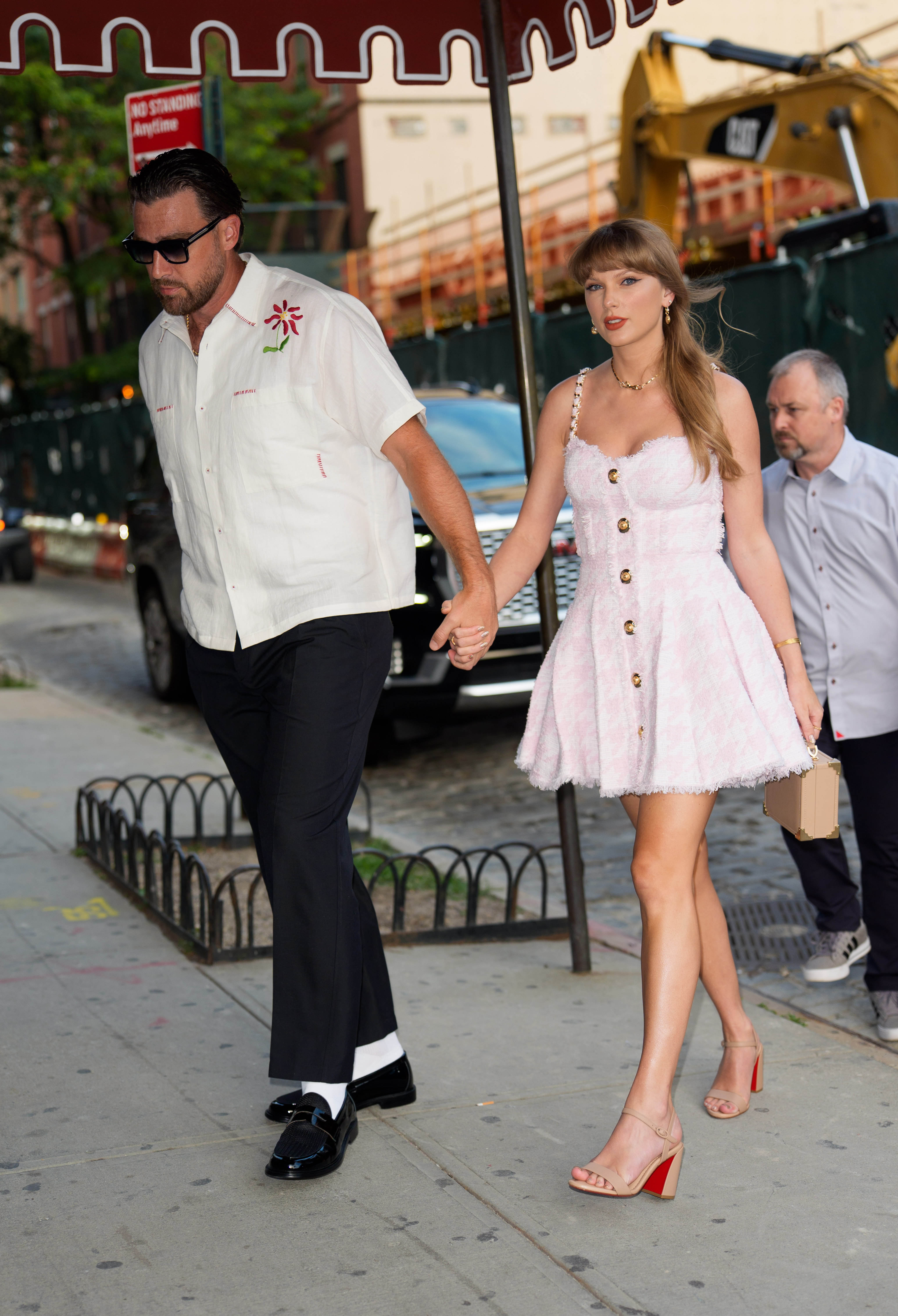 Taylor Swift wears a pink and white A-line minidress
