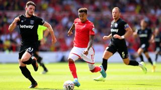 Jesse Lingard of Nottingham Forest runs with the ball whilst under pressure from Declan Rice of West Ham United during a Premier League match with Nottingham Fores