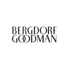 A woman wearing a white summer dress available at Bergdorf Goodman