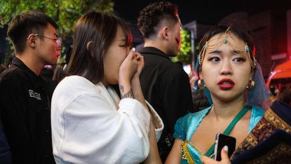 A woman reacts to the disaster in Itaewon in Seoul