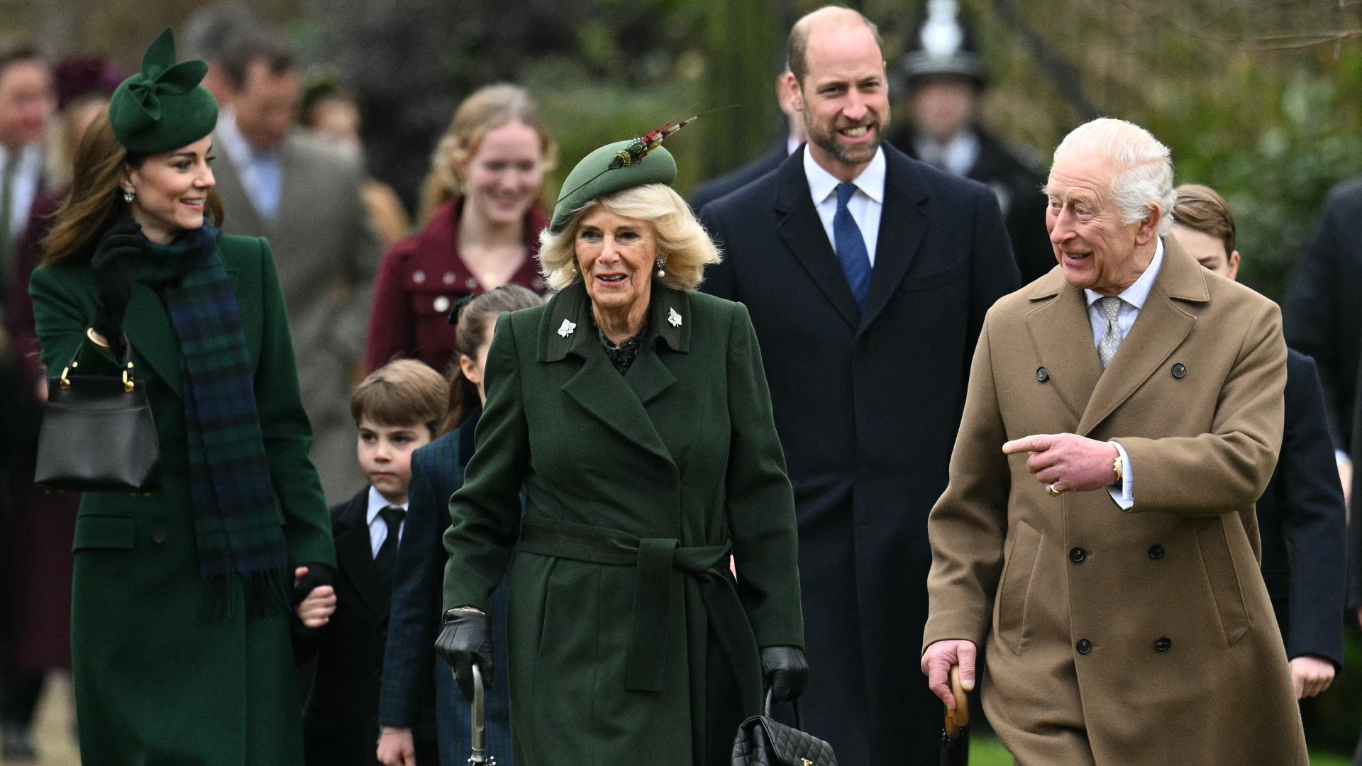 King Charles, Queen Camilla and the Royal Family walking to church on Christmas day wearing long coats and hats