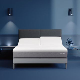 Sleep Number i8 Smart Bed against a blue bedroom wall.
