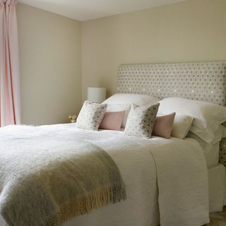 neutral wall guest bedroom with pink curtains