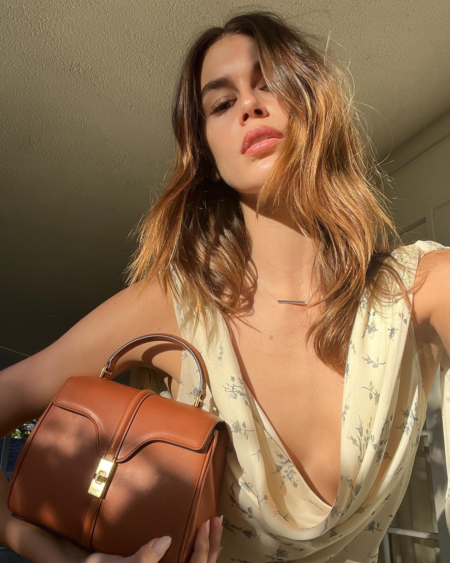 An image of Kaia Gerber carrying the Celine 16 bag.