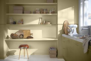 A yellow beige kitchen with built in shelving