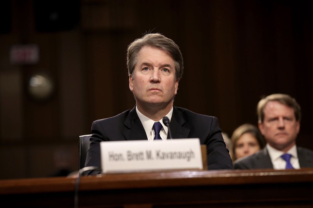 Brett Kavanaugh sits behind his name tag