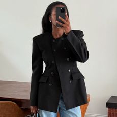 Influencer Marilyn dons a silk slip skirt, a Fair Isle sweater, and a white turtleneck layered underneath.