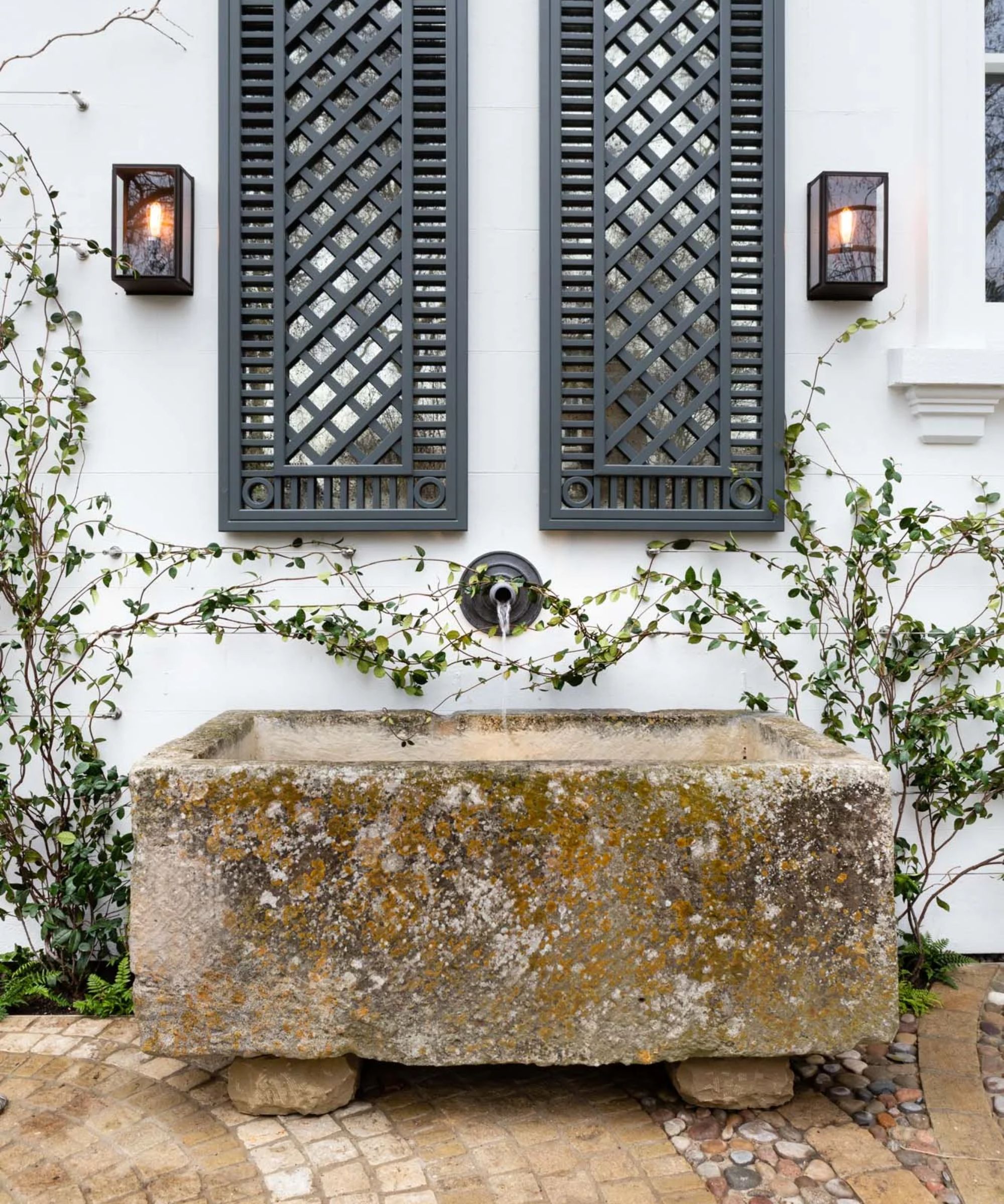 vintage lantern wall sconces with a vintage water trough by Butter Wakefield