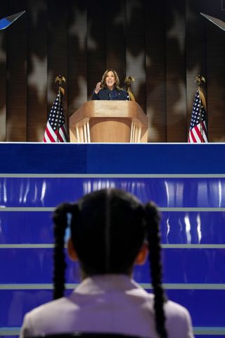 A girl stares at Kamala Harris