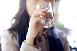 woman drinking water, tension headache