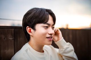 A lifestyle shot of the Glorange SteelSeries Arctis Gamebuds.