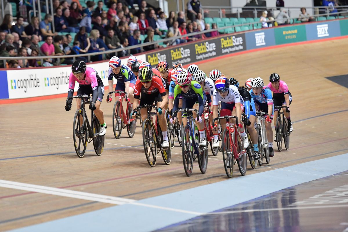 The women's peloton crosses the line