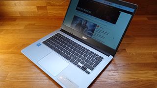 Acer Chromebook 314 review, a photo of a laptop on a wooden table with its lid open