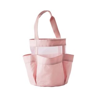 A pink fabric shower caddy with three pockets and a handle