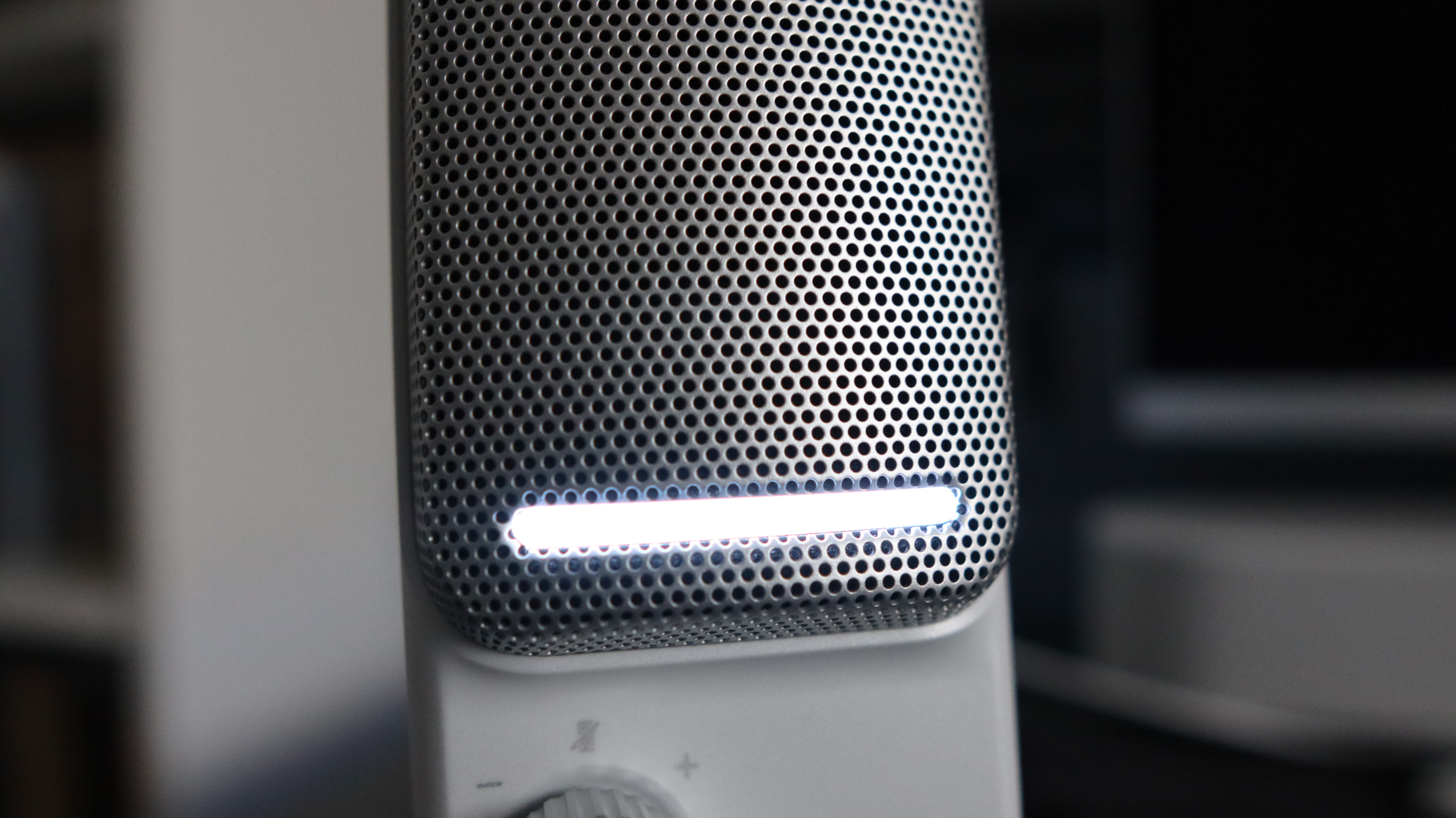 An NZXT Capsule Elite microphone set up on a desk with lighting enabled.