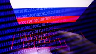 Russian flag displayed on a laptop screen and binary code code displayed on a screen are seen in this multiple exposure illustration photo taken in Krakow, Poland on February 16, 2022. (Photo illustration by Jakub Porzycki/NurPhoto via Getty Images)