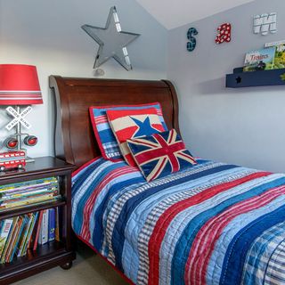 children bedroom with blue wall and wooden bed