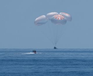 The SpaceX Crew Dragon Endeavour spacecraft is seen as it lands with NASA astronauts Robert Behnken and Douglas Hurley onboard in the Gulf of Mexico off the coast of Pensacola, Florida, Sunday, Aug. 2, 2020. 
