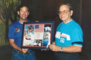 STS-37 payload specialist Jay Apt (left) presents Vern Estes with the space-flown Astron Scout model rocket in 1991.