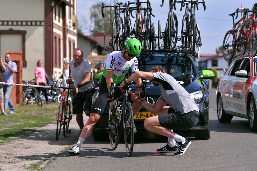 Mark Cavendish waits for a mechanic to get his bike in order during stage 2 in Poland