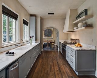 Kitchen with an interesting utensil above the oven