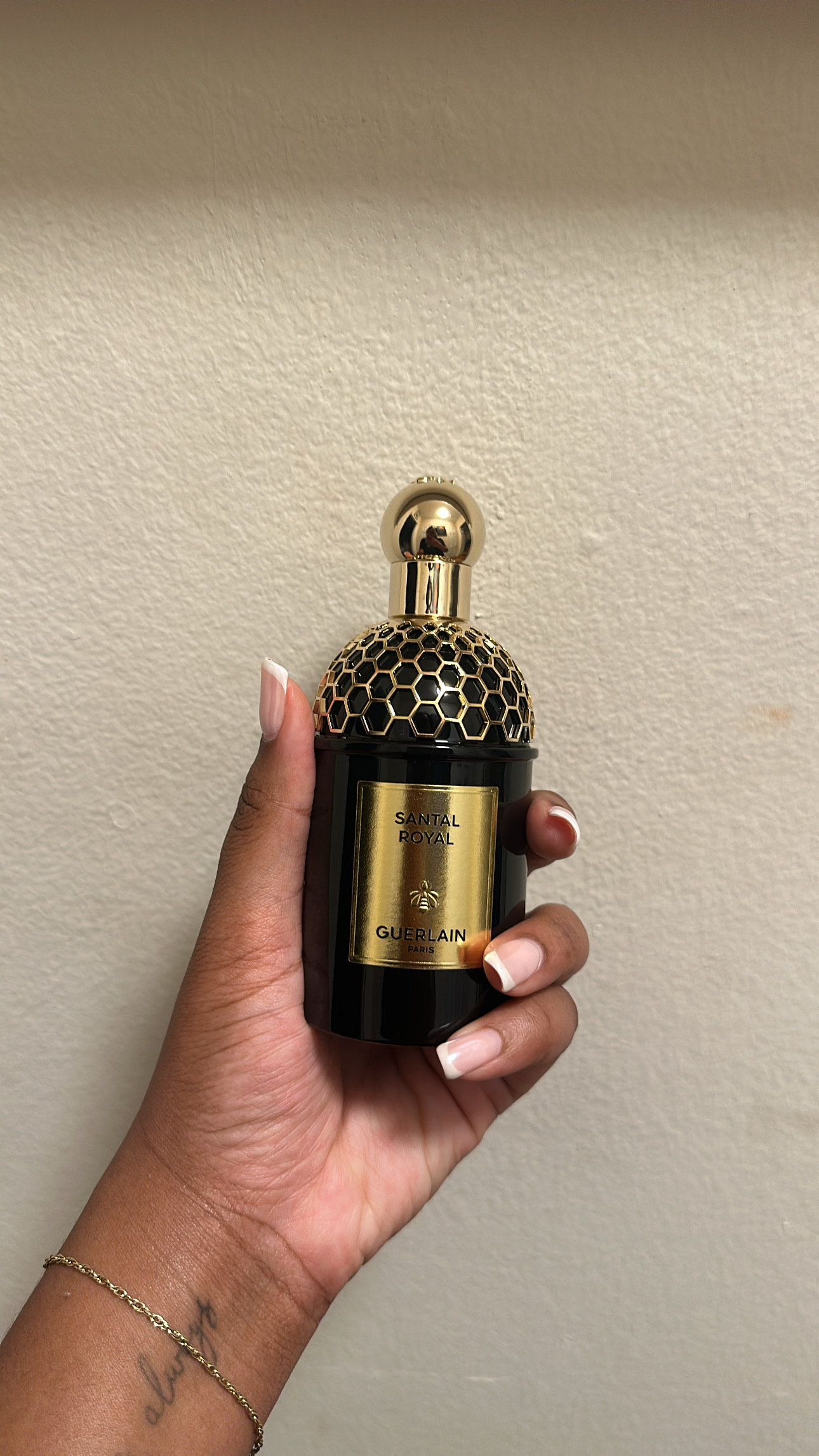 Ariel Baker is testing Guerlain Santal Royal perfume.