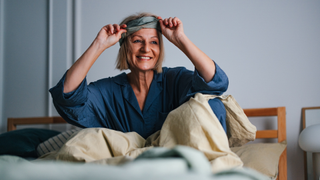 Woman taking off eye mask after waking up