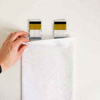 black strips folded fabric into white fabric