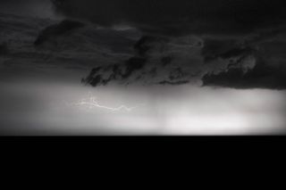 Black and white image of a storm with horizontal lightning